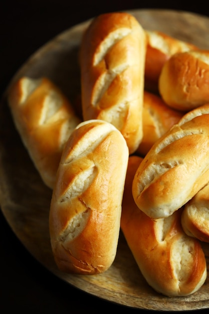 Fresh small buns on a wooden tray