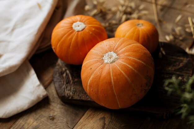 Fresh small pumpkins on the wooden table