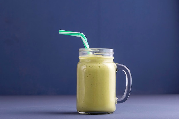 Fresh smoothies from avocado banana mango and honey on gray background Close up Concept healthy eating