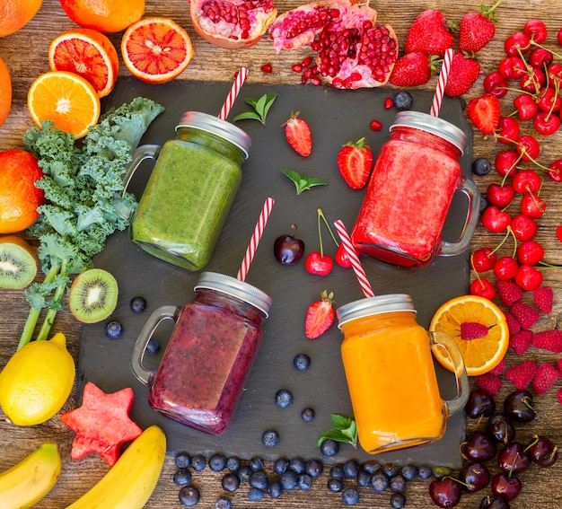 Fresh smoothy drinks in glass jars with igredients