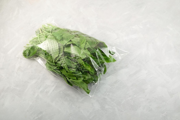 Fresh sorrel leaves in transparent plastic bag. Healthy ingredient for salads or soups Low carb diet