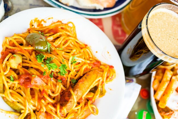 Fresh spaghetti with sausage peppers and onions in Italian restaurant.