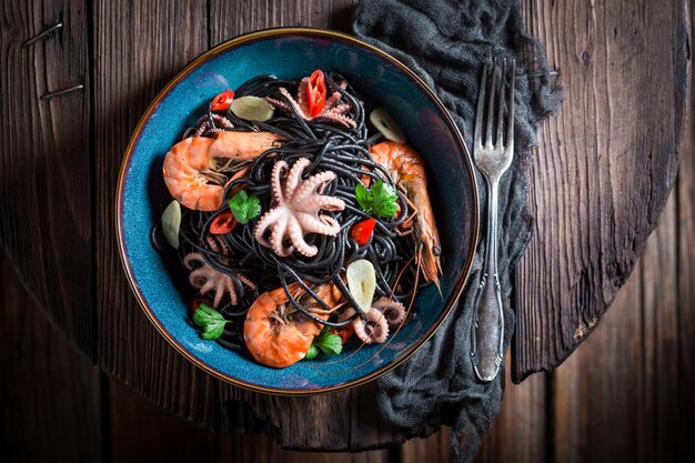 Fresh spaghetti with seafood made of octopus tiger prawns