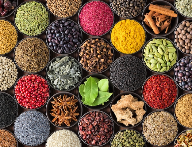 Fresh spices and herbs for food. Colorful condiments as wall, top view. lot seasonings in cups, on table