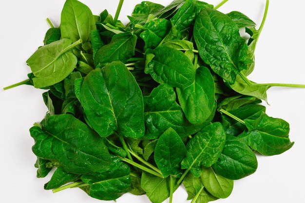 Fresh spinach leaves as background.