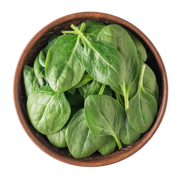 Fresh spinach leaves in a clay bowl isolated on a white background. Food for fitness. Vegetarian food. The view from the top.