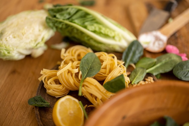 Fresh spinach leaves with raw pasta