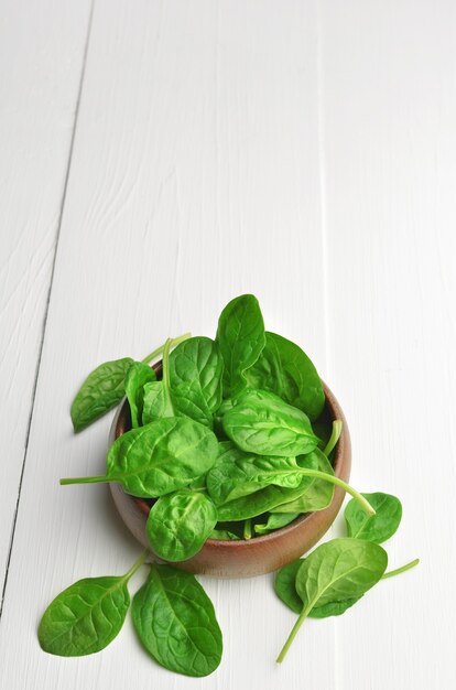 Fresh spinach leaves in wooden bowl