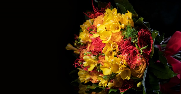 Fresh spring bouquet of yellow freesias and roses