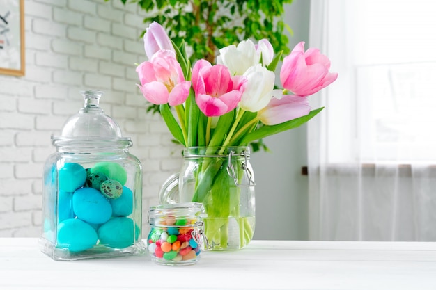 Fresh spring flowers with painted eggs for Easter celebration