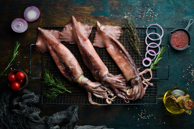 Fresh squid with spices on a dark stone background On a dark background