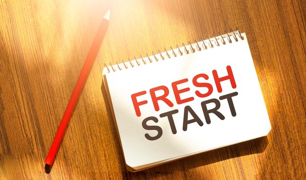 fresh start of the box on notebook on wooden background