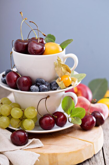 Fresh stone fruits and cherries in cups