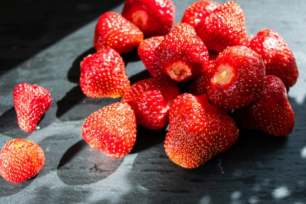 Fresh strawberries on black stone