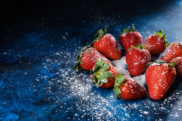 Fresh strawberries on a blue textured base