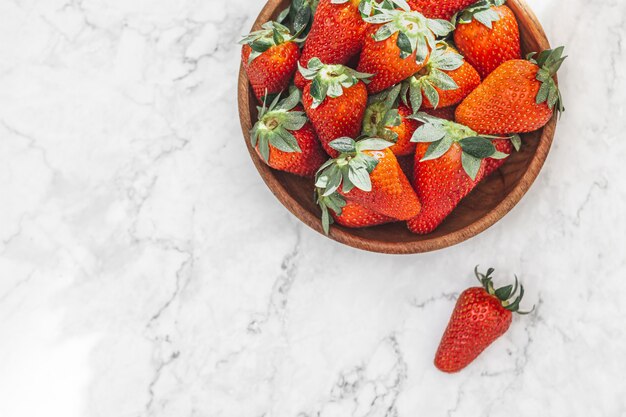 Fresh strawberries in a bowl on the table