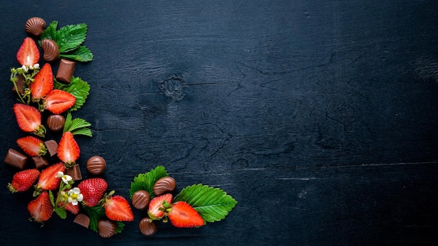 Fresh strawberries and chocolate Healthy food On Wooden background Top view Free space