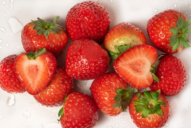 Fresh strawberries closeup in a cut on a white background