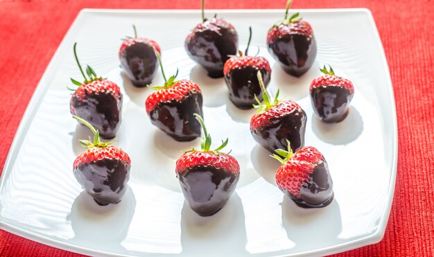 Fresh strawberries covered with dark chocolate