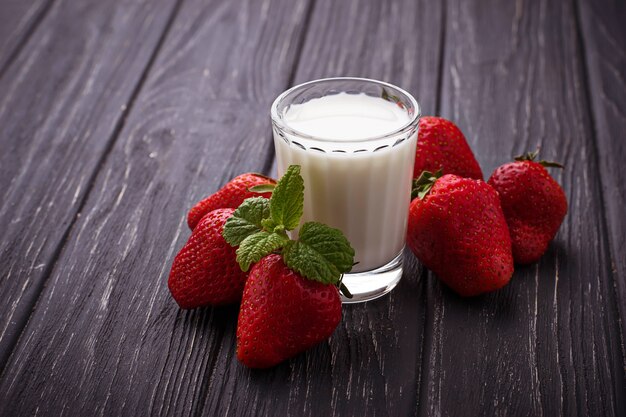 Fresh strawberries and glass of milk