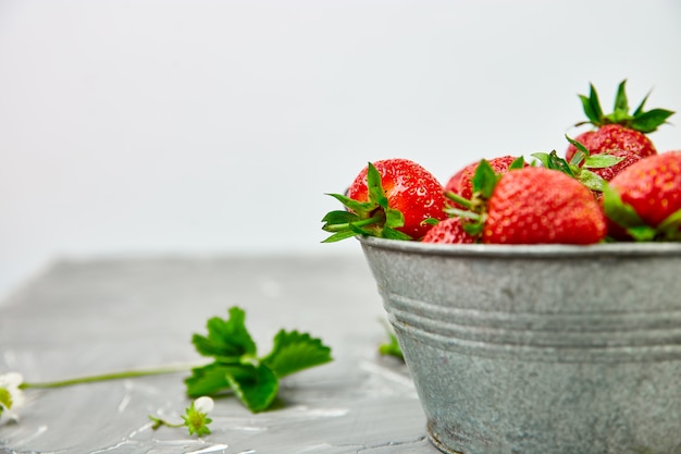 Fresh strawberries in grey bowl