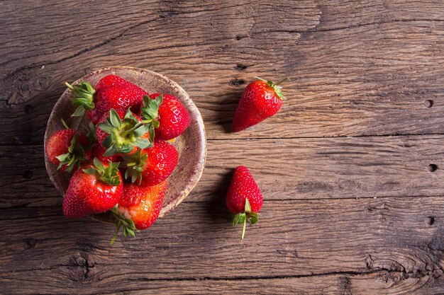 Fresh strawberries on old wooden background