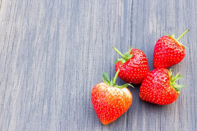 Fresh strawberries on old wooden background