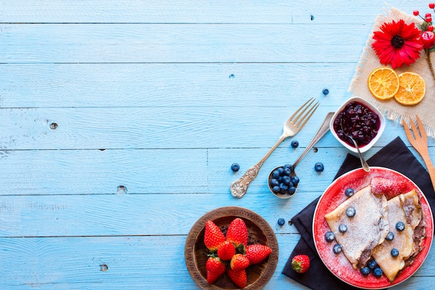 Fresh Strawberries Pancakes or Crepes with berries and chocolate