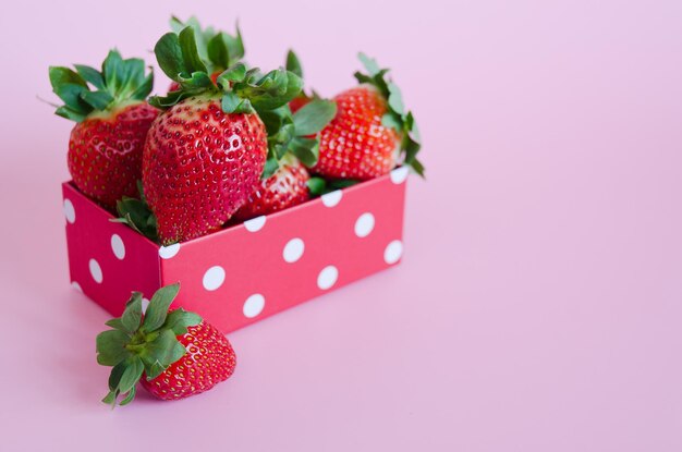 Fresh strawberries in red gift boxes close up. Love. Valentine's Day. Creative greeting card. Flat