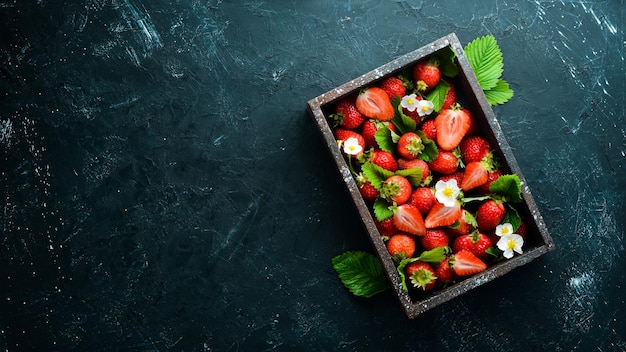 Fresh strawberries in a wooden box Berries Top view Free space for your text