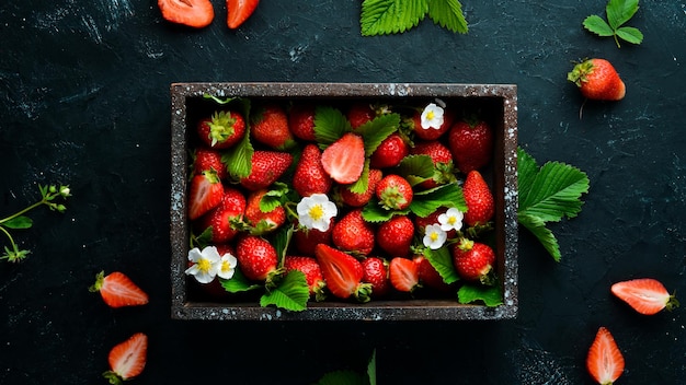 Fresh strawberries in a wooden box Berries Top view Free space for your text