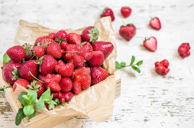 Fresh strawberries in a wooden box, concept of fresh summer berries