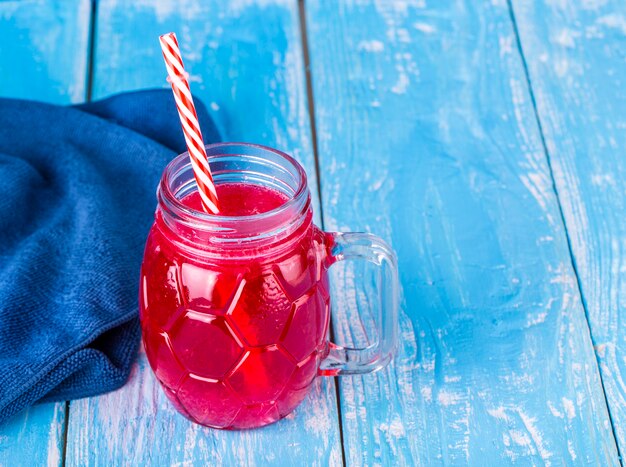 Fresh strawberry cocktail with fruits on a wooden rustic wall with copy space.