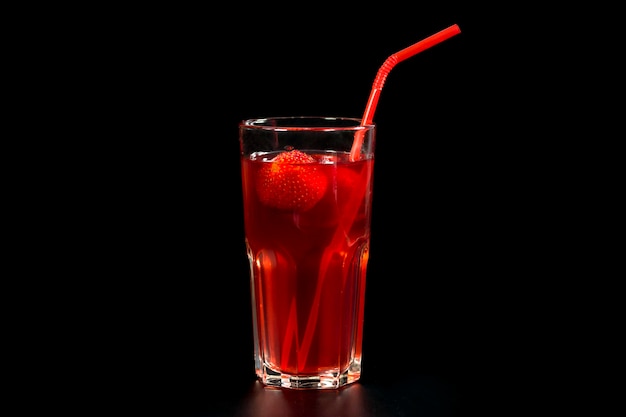 Fresh strawberry cocktail with strawberries on a black background Fresh lemonade