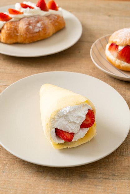 fresh strawberry and fresh cream crepe on plate