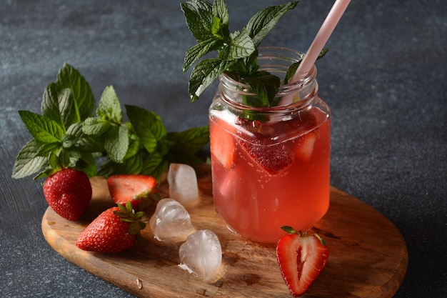 Fresh strawberry lemonade with ice and mint in glass