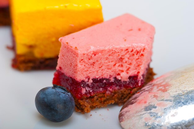 Fresh strawberry and mango mousse dessert cake with blueberry