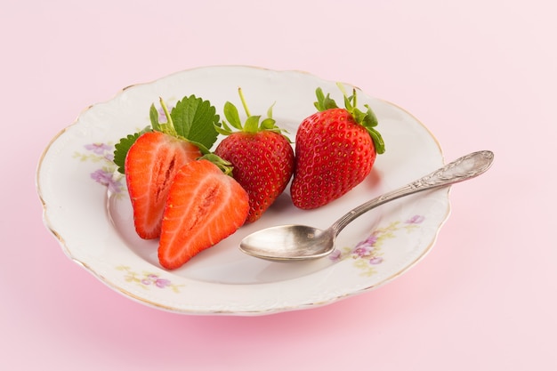 Fresh strawberry on old plate on a pink surface