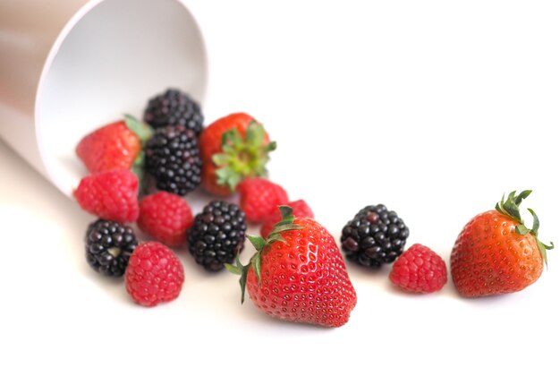 Fresh strawberry, raspberry and blackberry on wooden background, healthy food and diet.