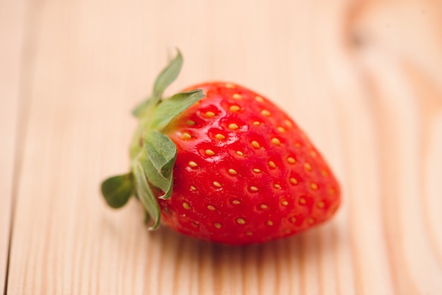 Fresh strawberry on wooden background.