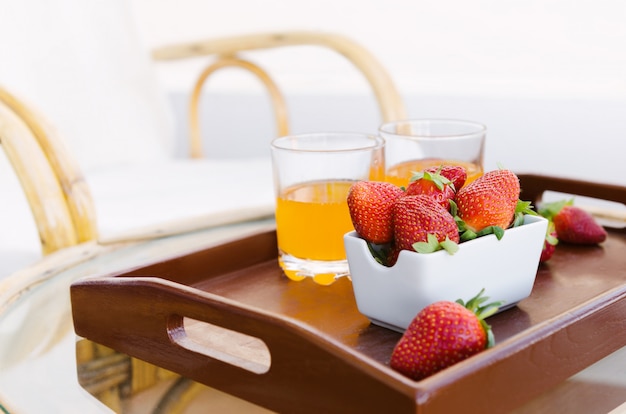Fresh strawberry on wooden tray