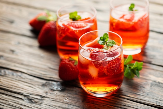 Fresh summer cocktail with ice, strawberry and mint