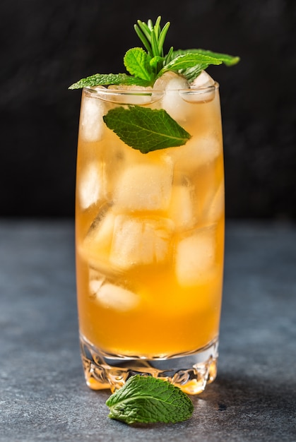 Fresh summer cocktail with orange juice and ice cubes. Glass of orange soda drink