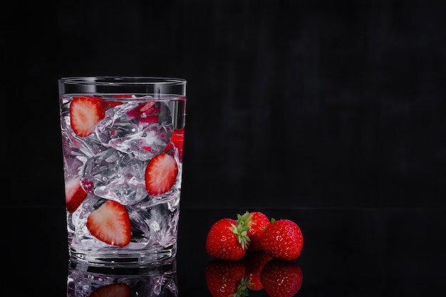 Fresh summer cocktail with strawberry and ice cubes