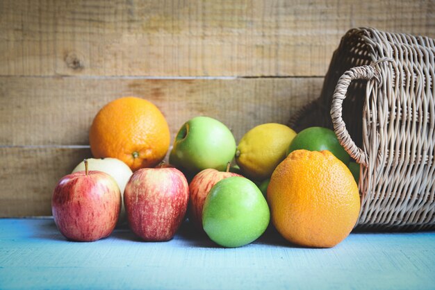 Fresh summer fruits in the basket on wooden table