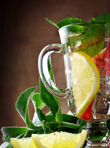 Fresh summer healthy drink with lemon and strawberries with ice.