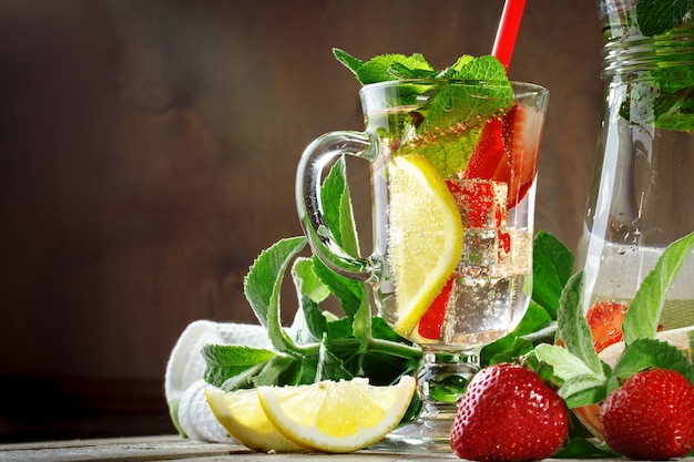 Fresh summer healthy drink with lemon and strawberries with ice.