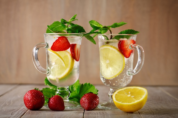 Fresh summer healthy drink with lemon and strawberries with ice