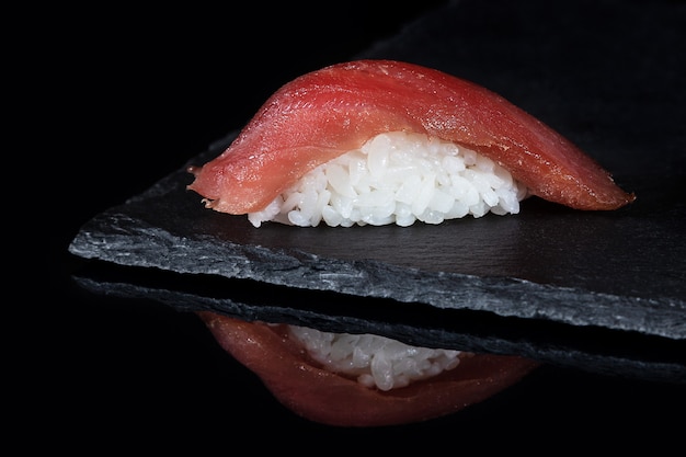 Fresh sushi with tuna on black desk