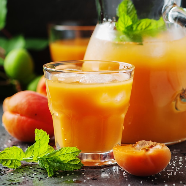 Fresh sweet apricot juice and mint, selective focus 